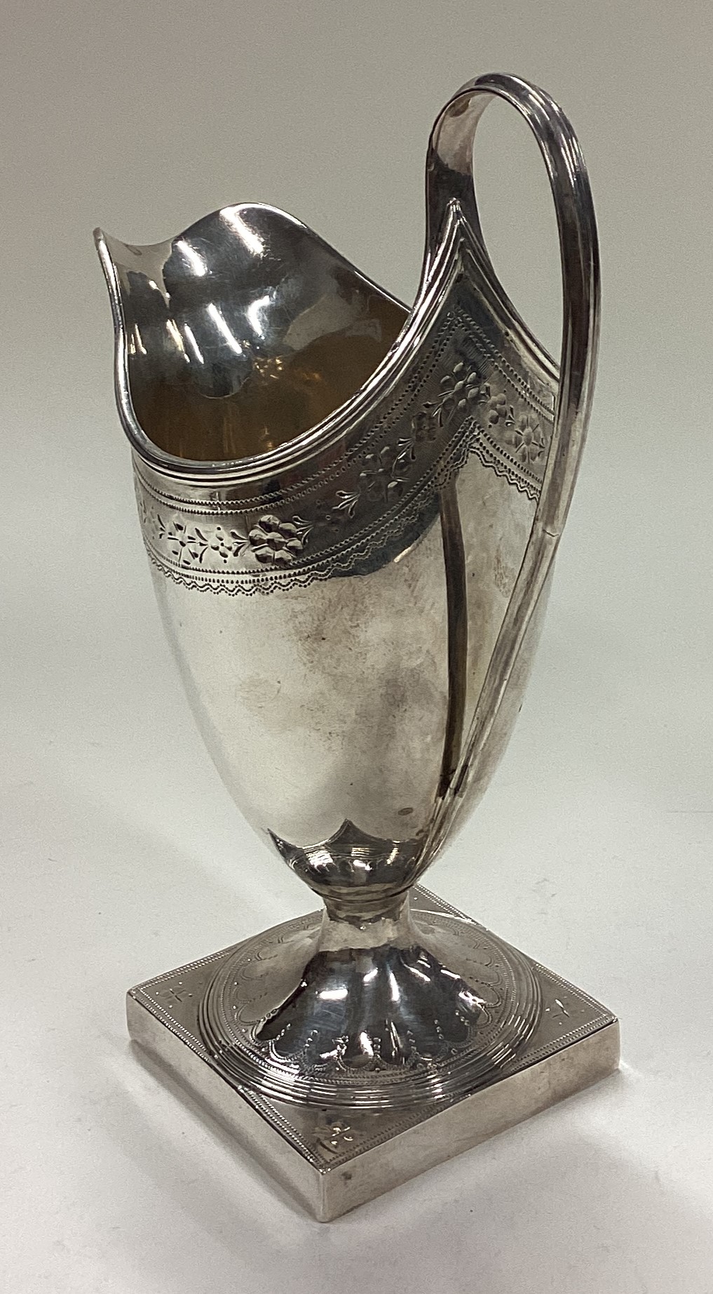 A George III silver jug with bright-cut decoration. - Image 2 of 3