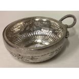 A large 19th Century French silver wine taster with chased vine decoration.