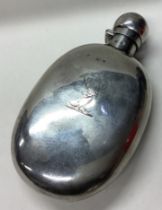 A Victorian silver flask with central armorial.