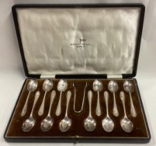 A good set of twelve silver coffee spoons together with matching tongs.