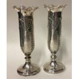 A pair of silver vases.