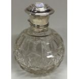 A silver and glass scent bottle.