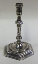 A George II silver taperstick with central armorial.