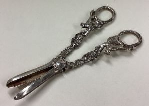 A pair of silver grape scissors cast with foxes.