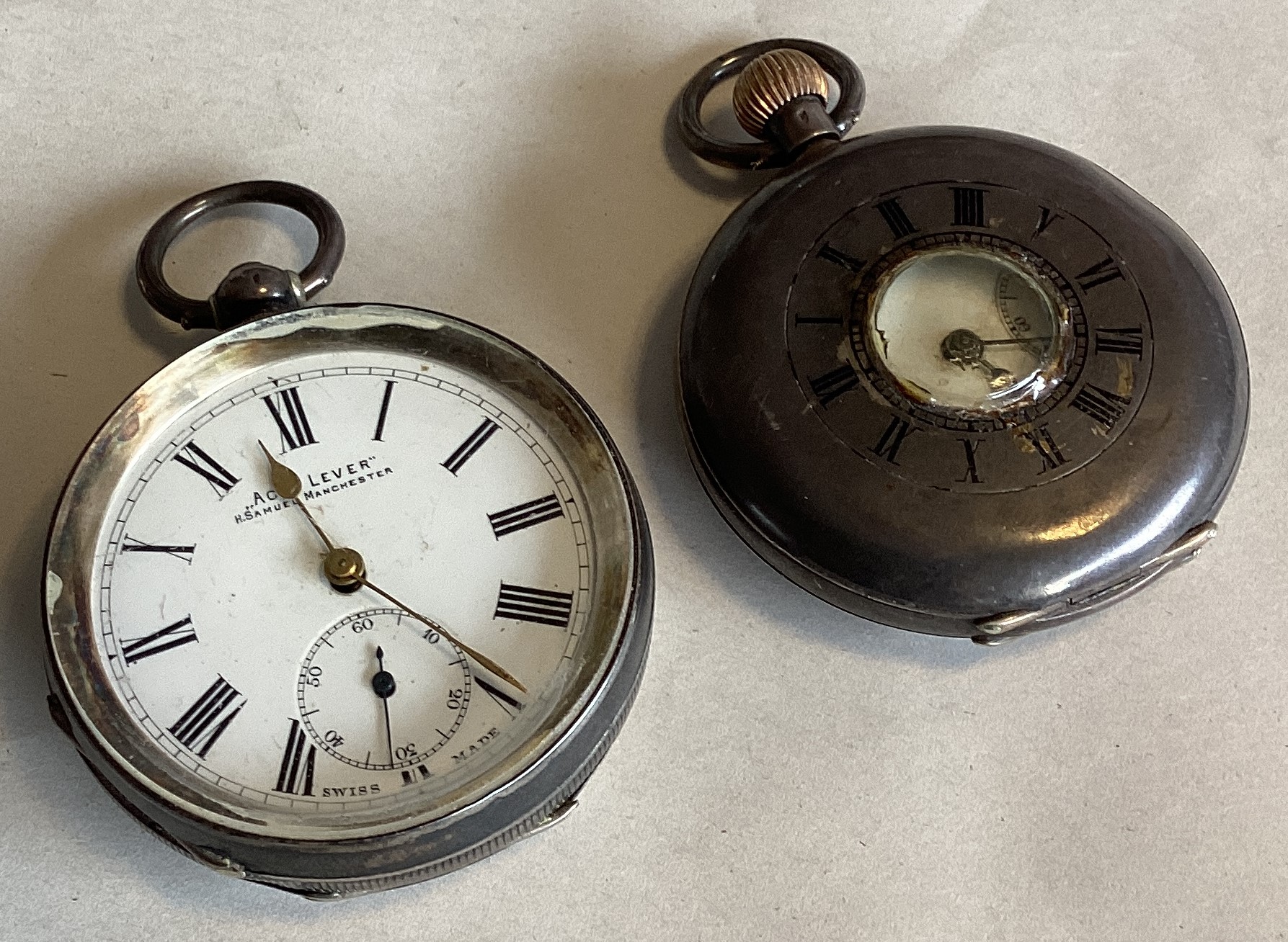 A silver open faced pocket watch together with one other.