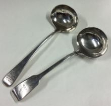A silver fiddle pattern sauce ladle together with one other.