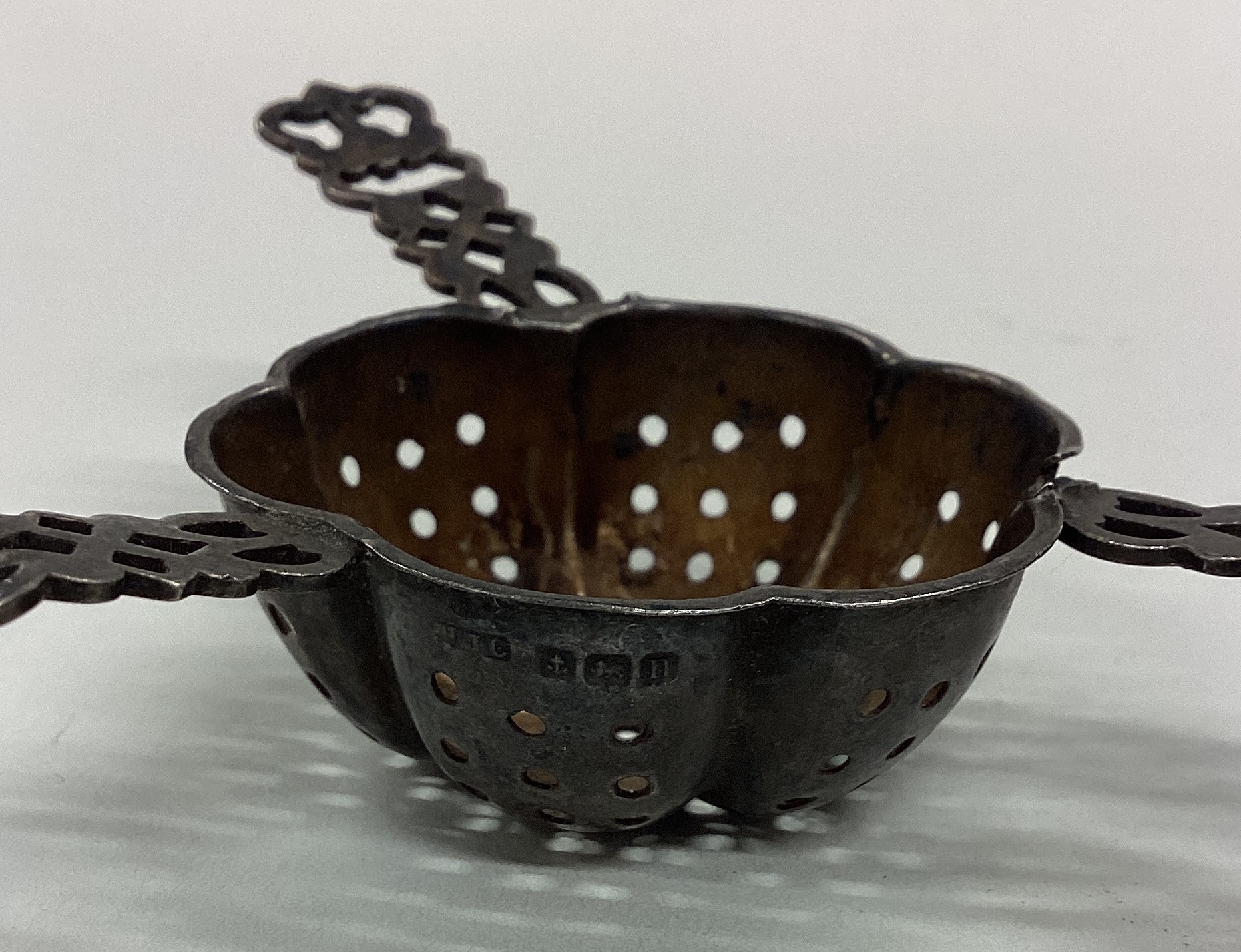 A heavy silver tea strainer with pierced decoration. - Image 2 of 2