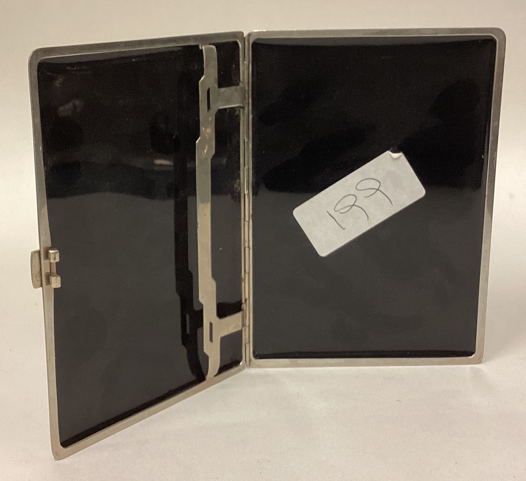 A large silver plated and black enamelled cigarette case. - Image 2 of 2