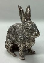 A novelty heavy silver figure of a hare in seated position.