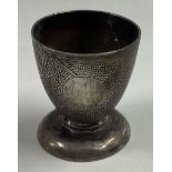 A Chinese silver egg cup with bamboo decoration.