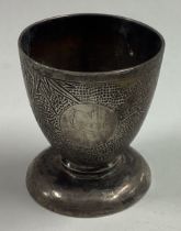 A Chinese silver egg cup with bamboo decoration.