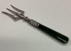 A silver three prong fork with agate handle.