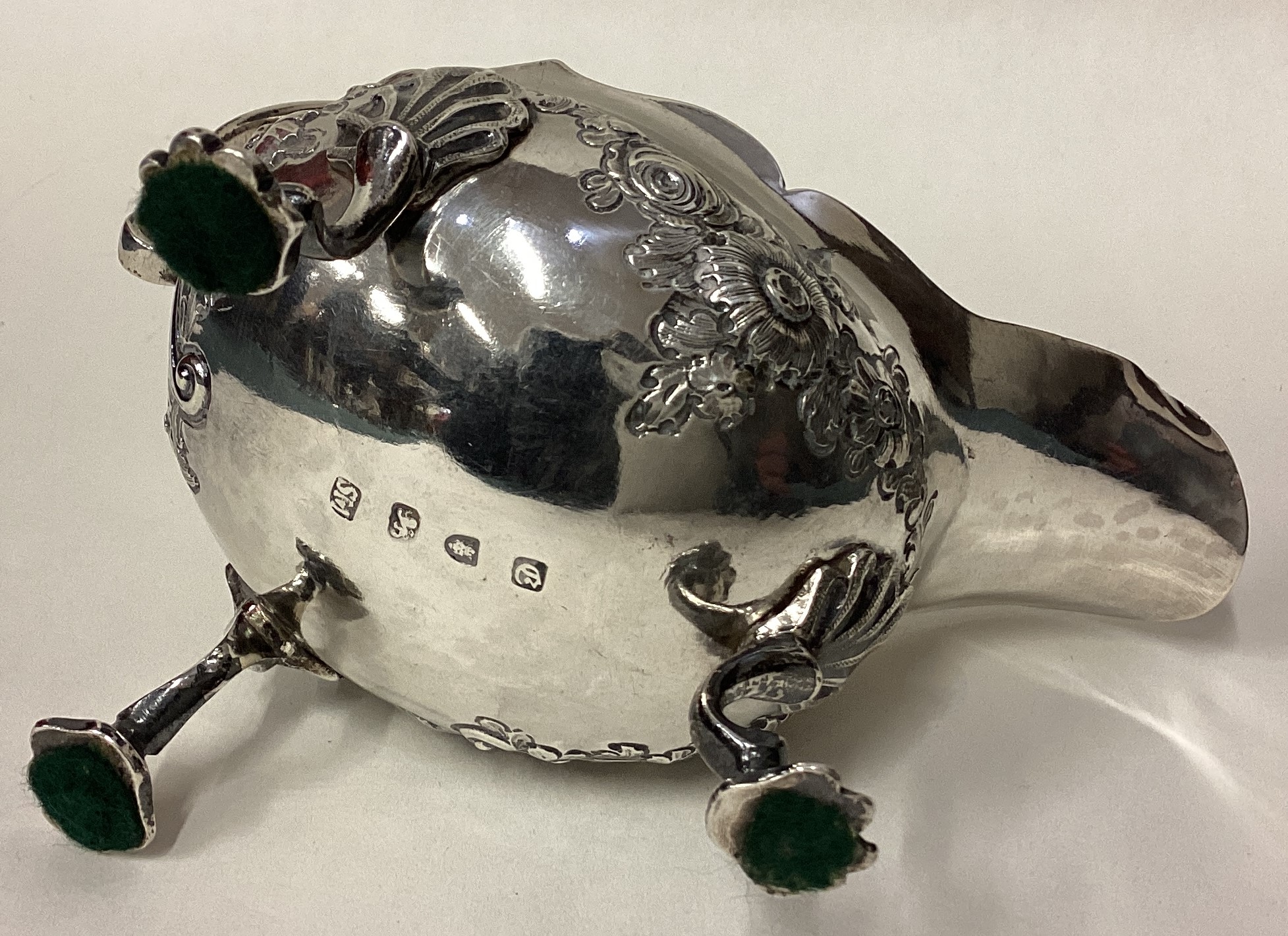 An 18th Century George III silver sauce boat with chased decoration. - Image 3 of 3