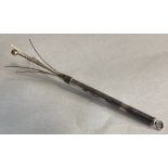 A small silver swizzle stick.