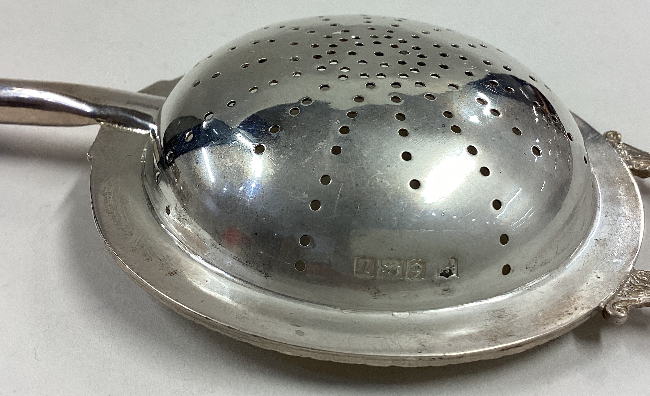 A heavy silver tea strainer with ebony handle and pierced decoration. - Image 2 of 2