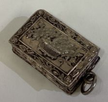 A Victorian silver vinaigrette decorated with basket of flowers.