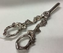 A cased pair of silver grape scissors chased with vine decoration.