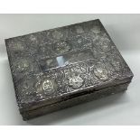 A Persian silver cigar box chased with Malaysian states.