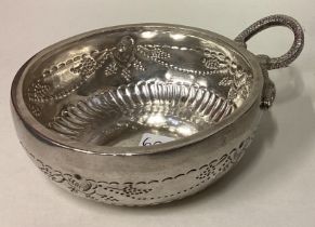 A large 19th Century French silver wine taster with chased vine decoration.