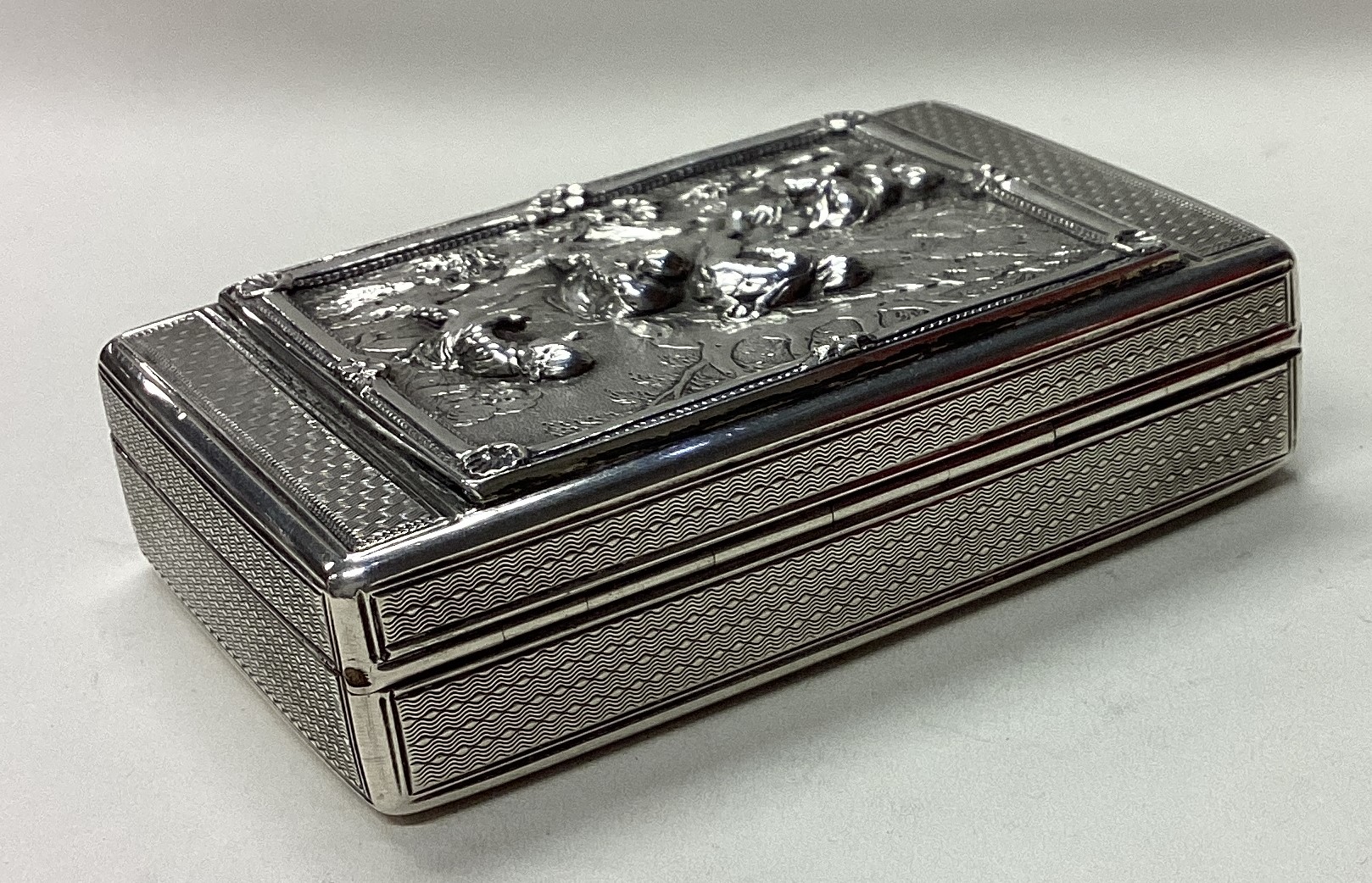 A rare Victorian silver snuff box cast with figural scenes and trees. - Image 4 of 4