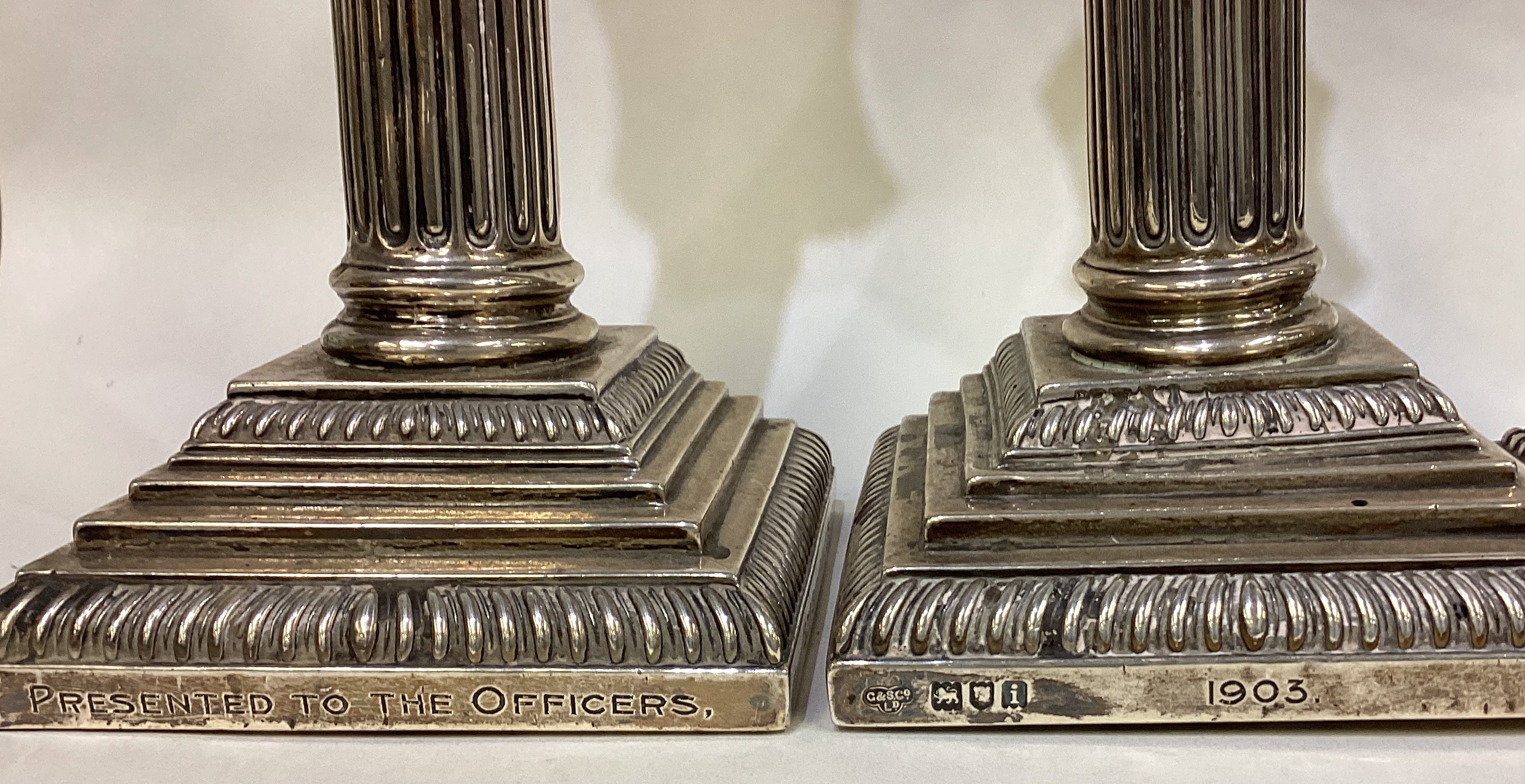 A heavy pair of silver Corinthian column candlesticks of typical form together with one other. - Image 3 of 4