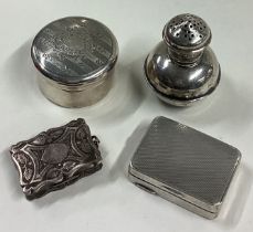 A small silver pill box together with a pepper etc.