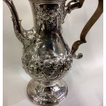 A fine and oversized George III silver coffee pot.