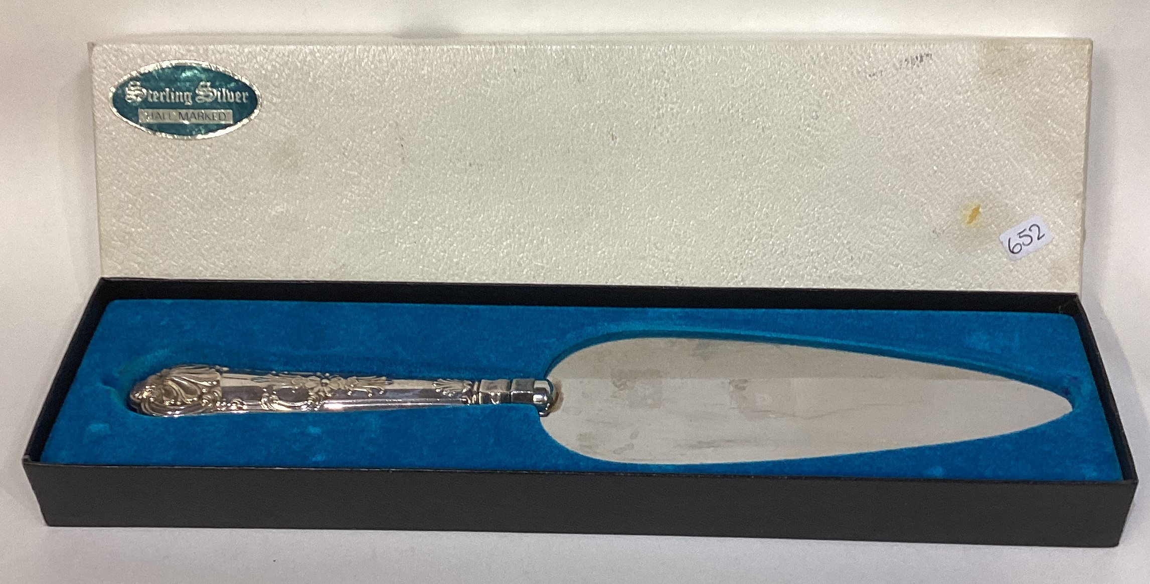 A large silver mounted cake slice.
