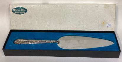 A large silver mounted cake slice.