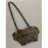 A Victorian silver wine label for 'Madeira'.