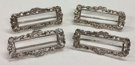 A set of four American silver menu holders.