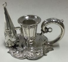 A small Victorian silver chamberstick with matching snuffer.