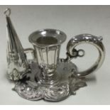 A small Victorian silver chamberstick with matching snuffer.