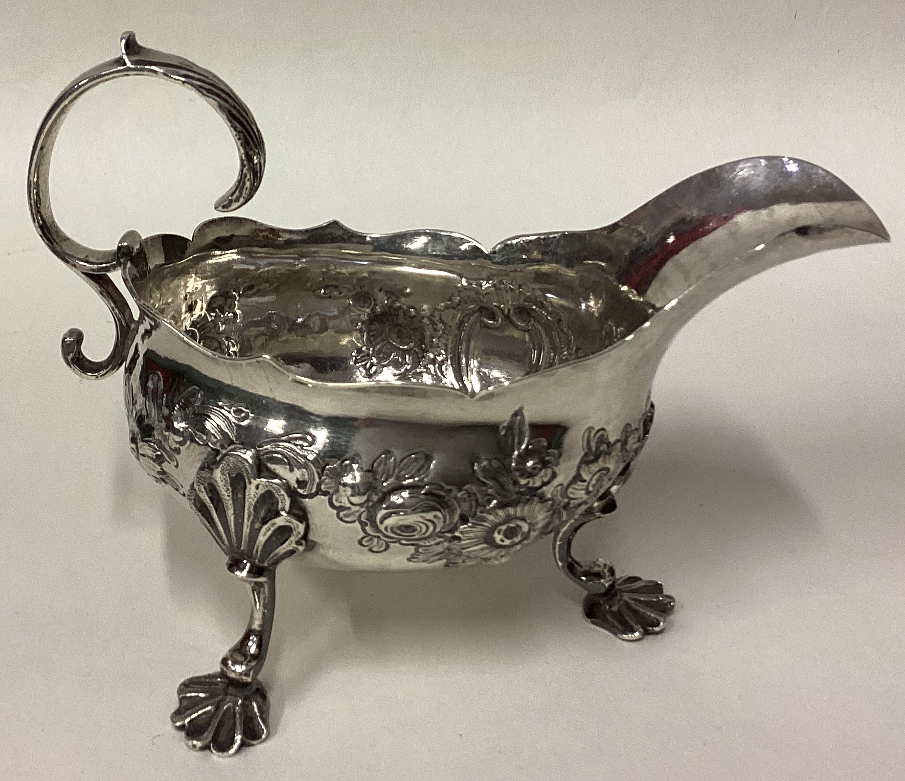 An 18th Century George III silver sauce boat with chased decoration. - Image 2 of 3