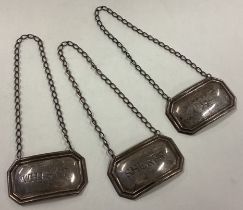 A good set of three silver wine labels on suspension chains.