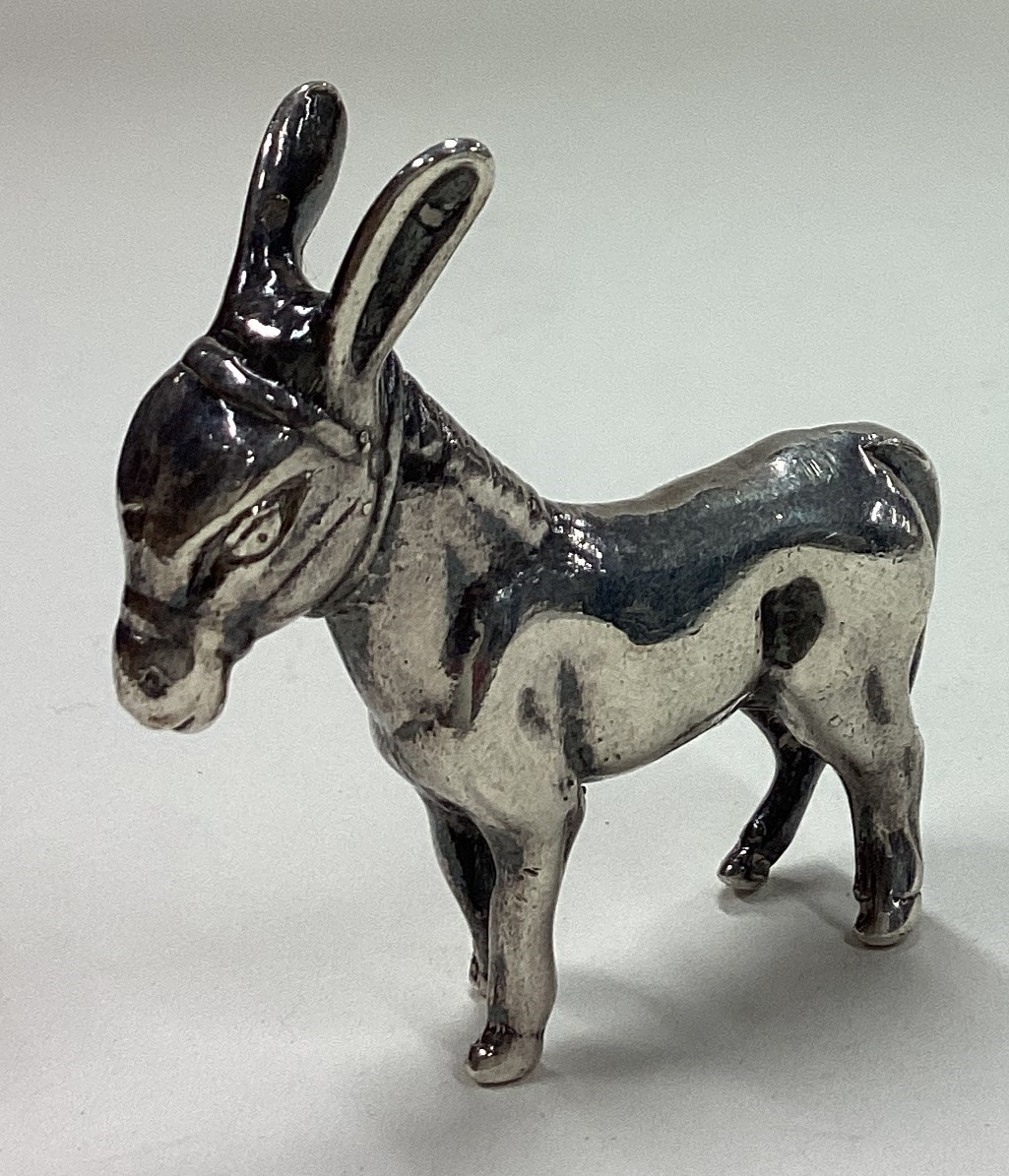 A contemporary silver figure of a donkey.