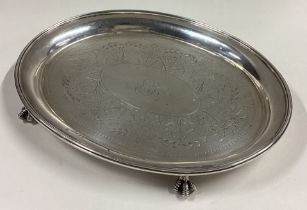 A Victorian silver teapot stand with bright-cut decoration.