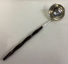 A 19th Century Scottish silver toddy ladle with whalebone handle.