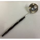 A 19th Century Scottish silver toddy ladle with whalebone handle.