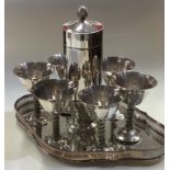 A good silver plated cocktail shaker together with goblets.