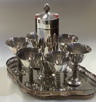 A good silver plated cocktail shaker together with goblets.