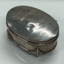 A silver jewellery box on feet with hinged lid.