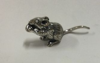 A silver figure of a mouse.