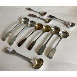 A large collection of Victorian and other silver fiddle pattern salt spoons.