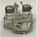 A Victorian silver cruet set on stand. London.