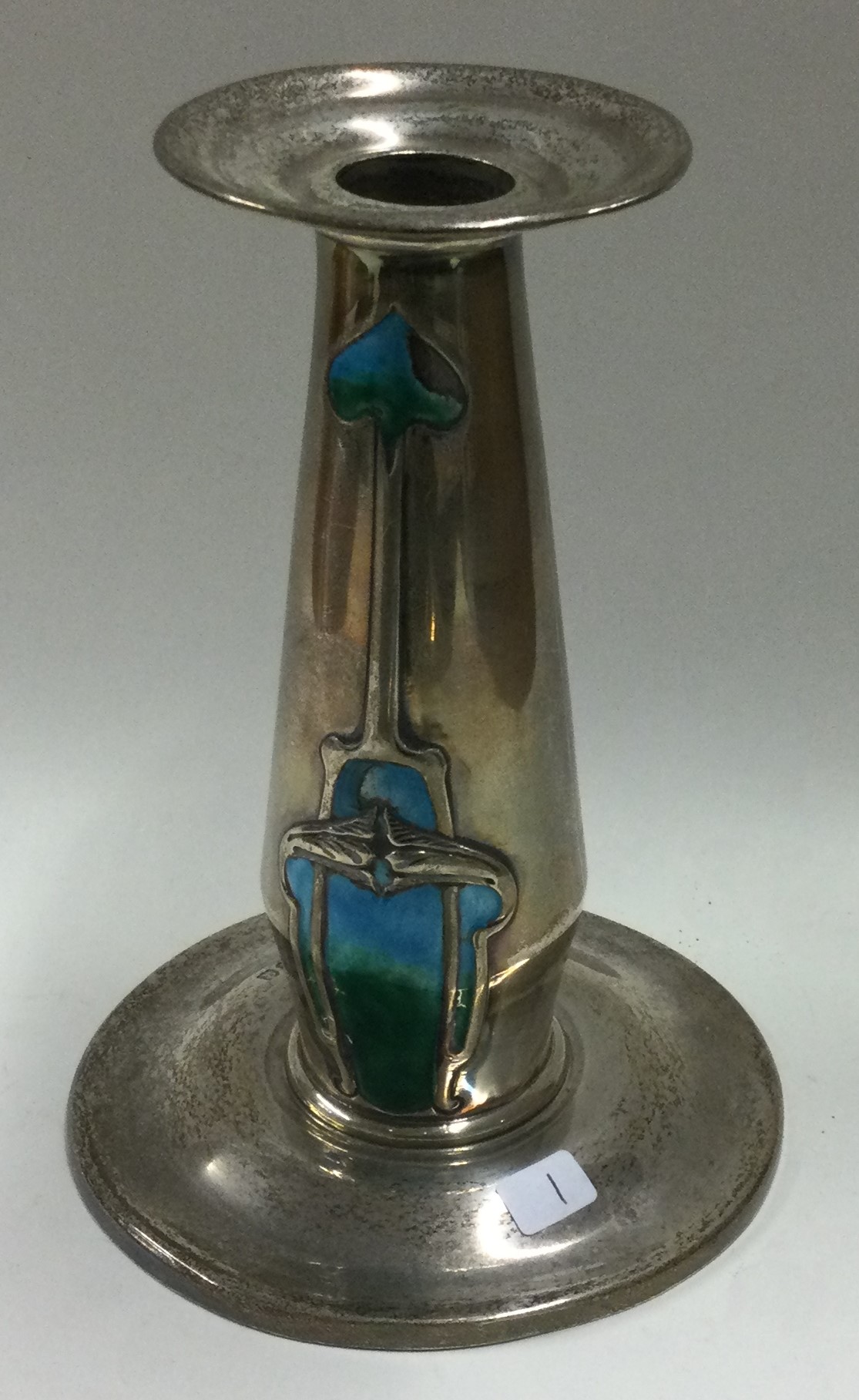 A stylish silver and enamelled candlestick. London.