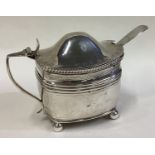 An early 19th Century silver mustard pot with BGL and spoon.