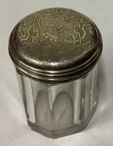 A William IV silver gilt and glass jar with bright-cut decoration.