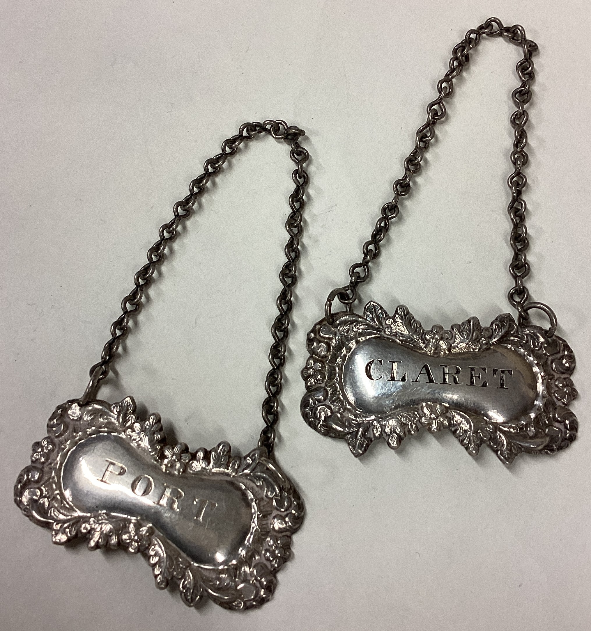 A pair of Victorian silver wine labels for 'Port' and 'Claret'.