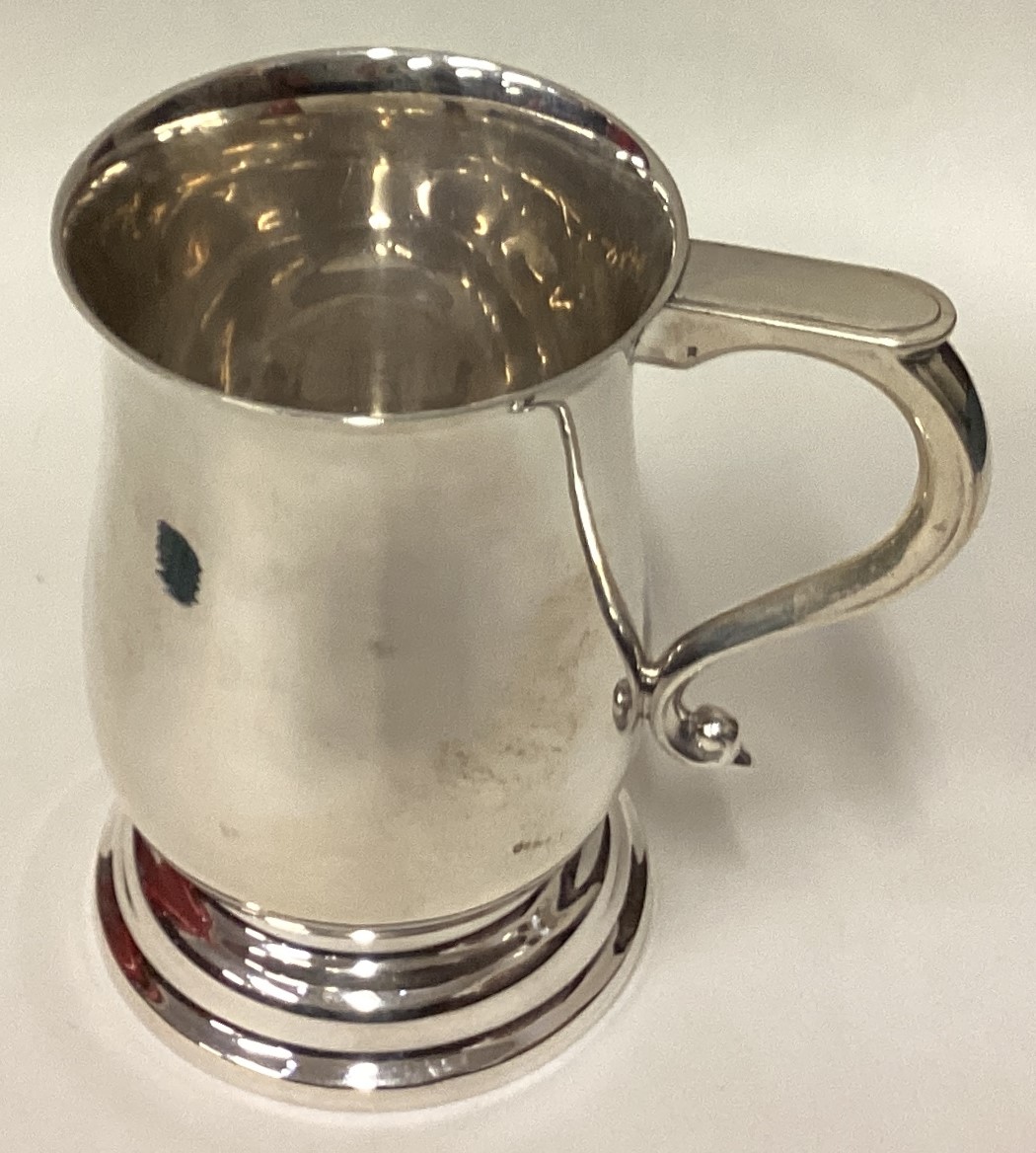 A large silver pint mug in the Georgian style.